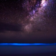 Illustration for article titled Rare view of the ocean glowing blue against the Milky Way